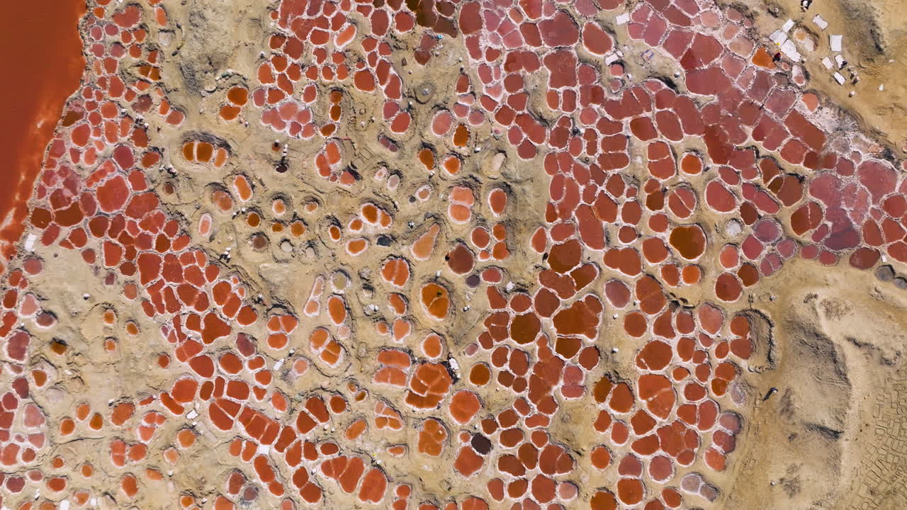 Above View Of The Red Salt Flats Situated In The Qobba Area Of Socotra In Yemen. Aerial Ascending Shot