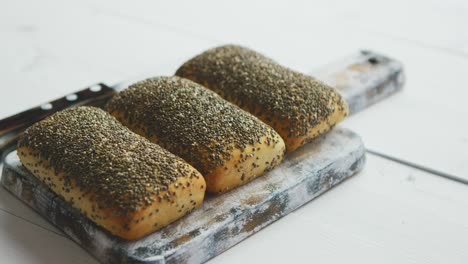 Closeup-of-whole-grain-bread-with-seeds-on-a-rustic-wooden-board