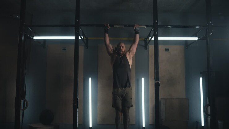 Man Performing Pull-ups in Gym