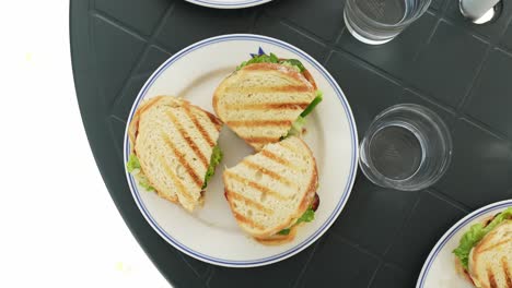 delicious toast sandwiches in white plate, top down view