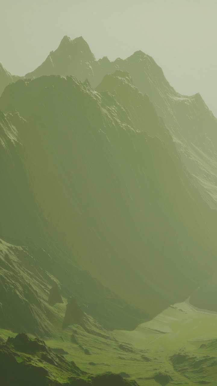 Misty mountains paint a serene landscape under soft golden light