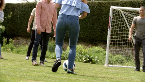 adult friends having fun with a football on a playing field