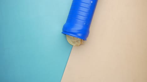 hand taking a chip from a blue container