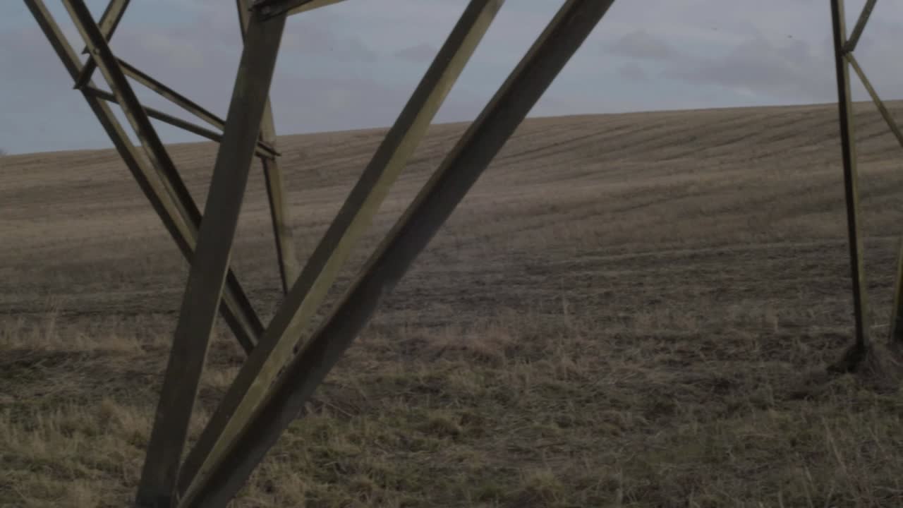 Electricity power pylon base in farmers field