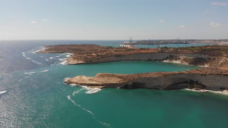 Aerial-drone-video-from-eastern-Malta,-Marsaxlokk-area,-Il-Hofra-l-Kbira-bay