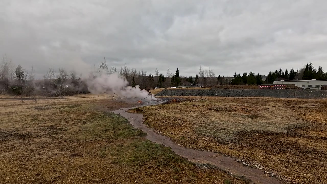 Authentic footage of a natural geothermal hot spring emitting steam in the rugged Iceland wilderness. Perfect for sustainability and ecofriendly energy concepts.