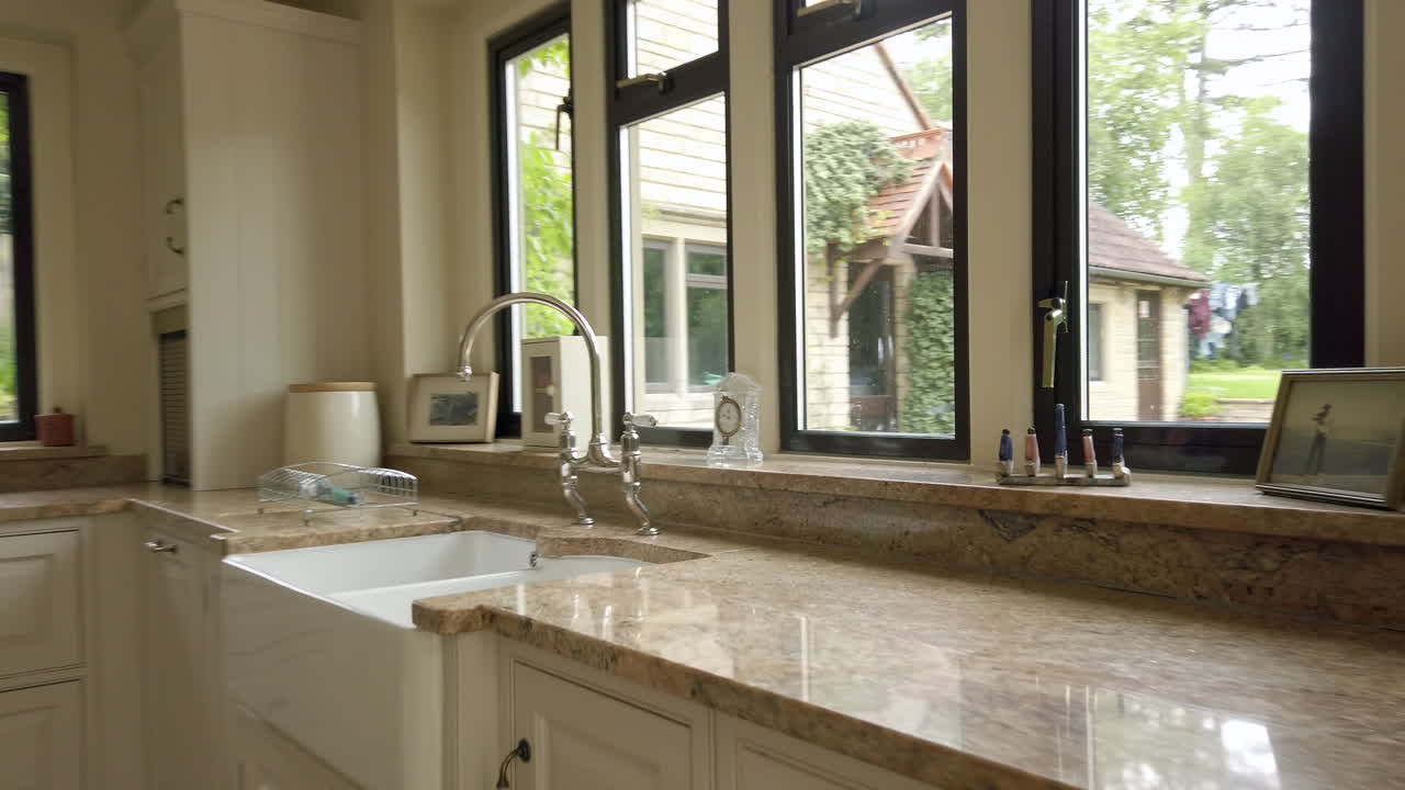 Moving Shot focussing on a Sink and Tap with a Garden View