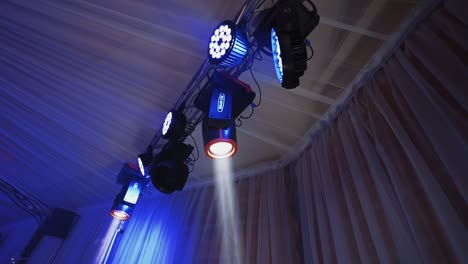 musical spotlights. colorful lights from projectors shimmering in the dancing hall. modern equipment shining with different colors.