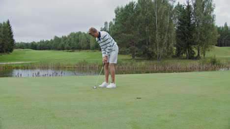 man putting on golf course