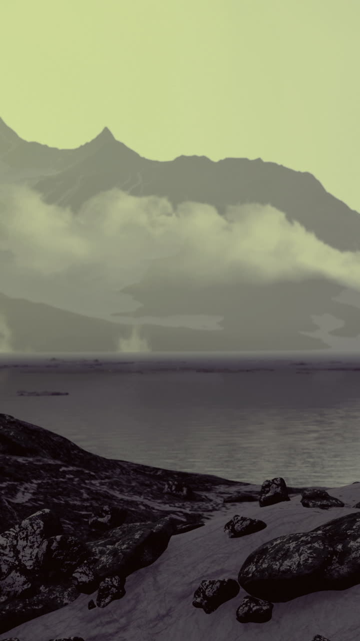 Misty mountains rise above a tranquil lake under soft evening light