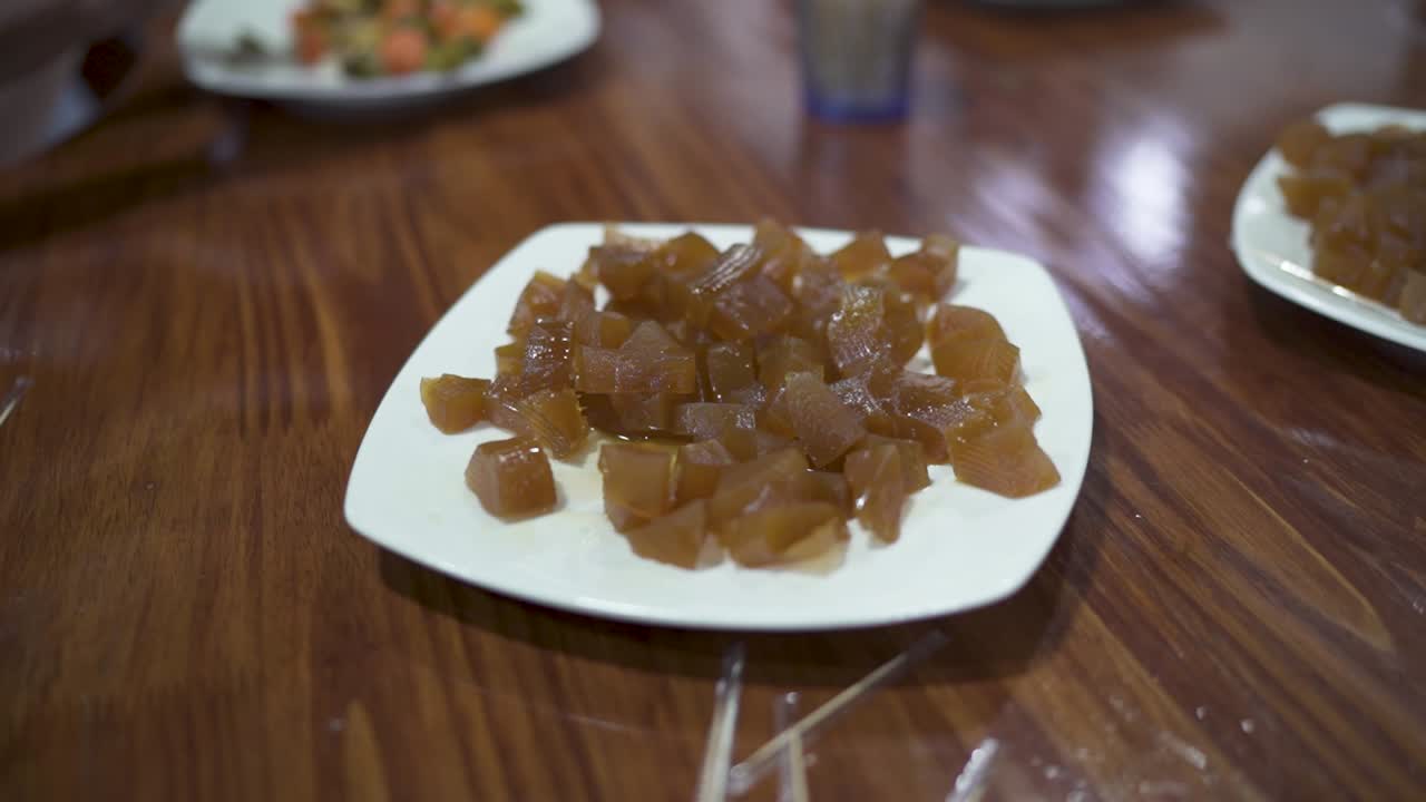 Close-up view of a traditional Latin American dessert on a plate, made from papaya or mamón in syrup