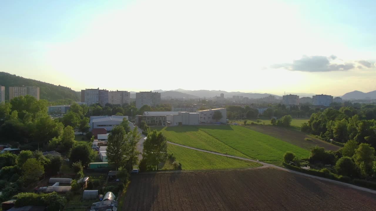 Cerknica, Slovenia, at golden hour. Aerial shot flying over the town