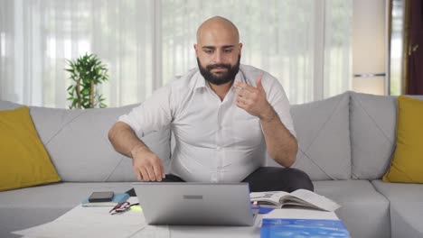 Home-office-worker-man-finds-what-he-is-looking-for-on-the-table.