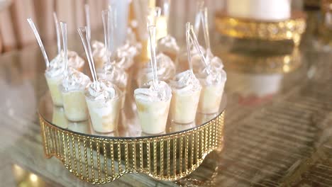 milk biscuit candy in small glasses at wedding event, video shot in detail of the buffet. closed video hd