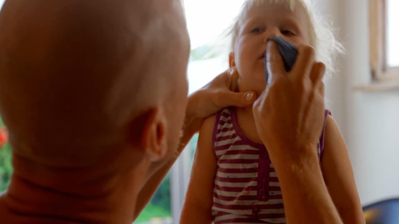 Father wiping his daughters mouth 4k