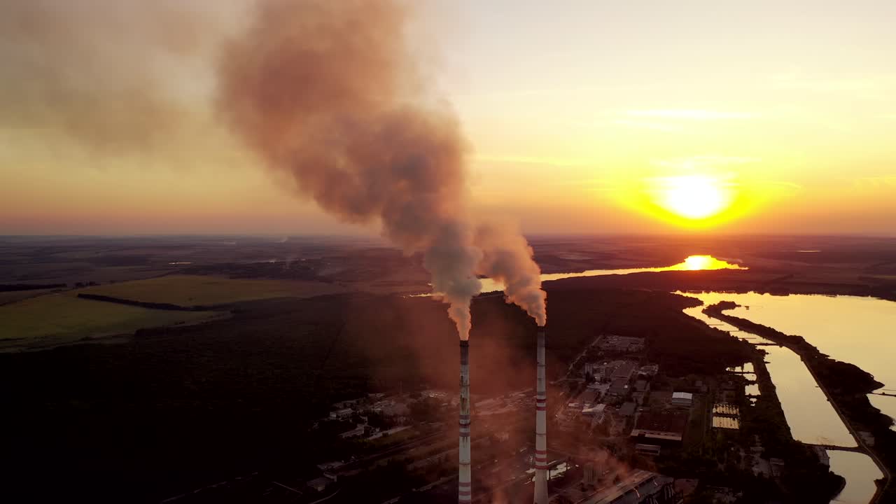Aerial view of pipes with smoke. Factory with smoke coming out of chimneys