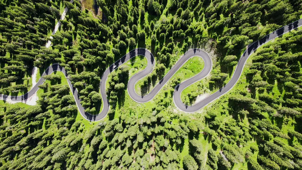 Passo Giau serpentine road in sunny Italian Alps, Top-Down drone view, sunny Day