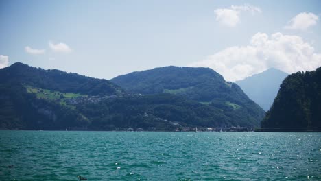 Tranquil-View-of-Hillside-Highway-in-Distance-of-Mountain-Lake---Hergiswil-Switzerland-Mountains-in-4K