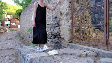 a woman looking into the building through gate