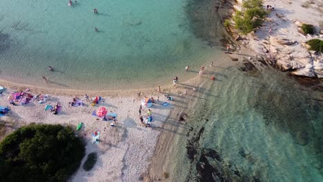 people on holiday summer vacation at the mediterranean beach of halkidiki in northern greece