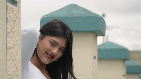 close up cinematic portrait clip of a young brunette latin girl looking at the camera and smiling