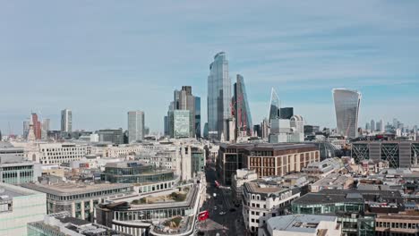 slow drone shot towards bank and city of london skyscrapers over queen victoria street mansion house