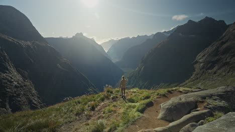 Woman-reaching-Gertrude-Saddle-hike-viewpoint-with-bright-afternoon-sunlight