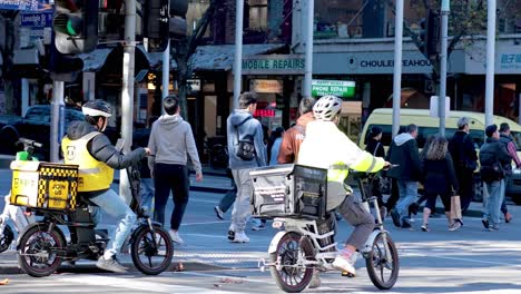 pedestrians and cyclists crossing a busy intersection