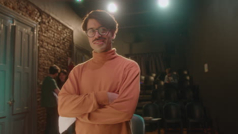 portrait of confident stage director at work in theater