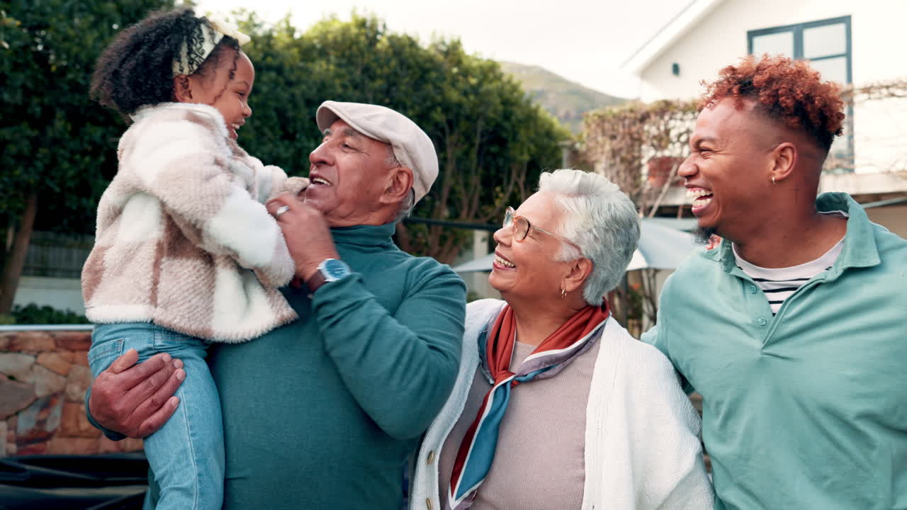 Happy Multi-Generational Family Laughing and Playing Together Outdoors