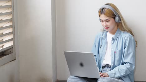 Two Asian girls student partners are working on a laptop help study together