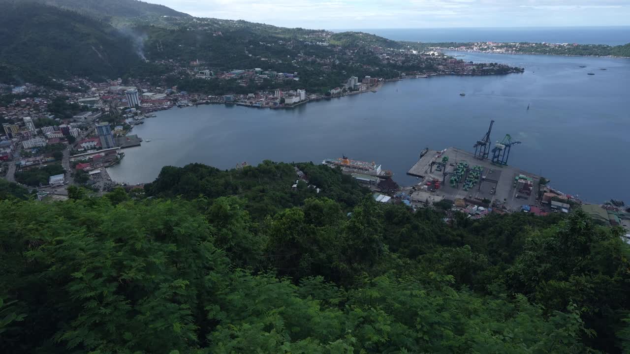 Landscape of residential area, port and container ship, bridge around gulf in Jayapura City, Papua, Indonesia