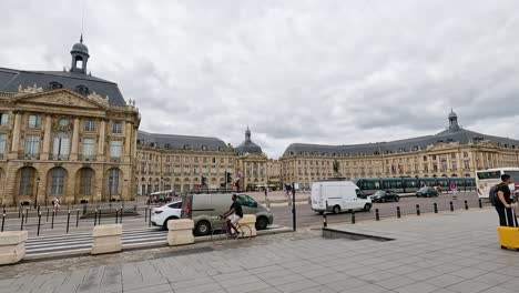 people and vehicles in bustling city square