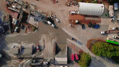Aerial-view-of-ready-mix-cement-supplier-with-mixer-trucks-unloading-wet-concret