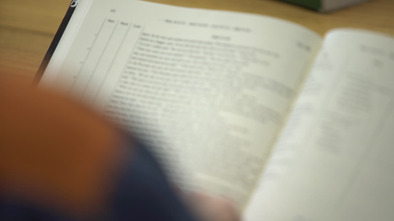 Prisoner inmate reading the Bible while incarcerated behind bars in prison jail