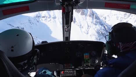 Helicopter-Flying-Through-White-Snowy-Mountains-In-Colorado,-USA