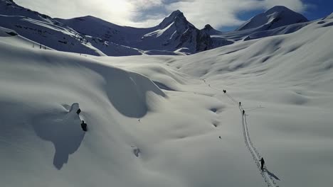 drone flying past backcountry skiers ascending on skintrack