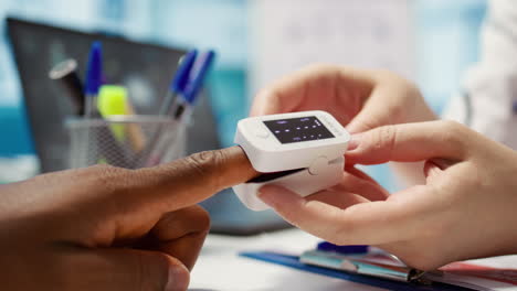 el médico experto utiliza un oxímetro para medir la saturación de oxígeno