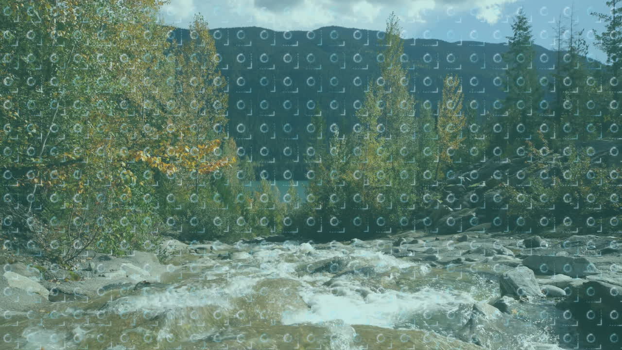 Mountain river rapids flowing through rocky valley, showcasing smooth boulders and autumn trees