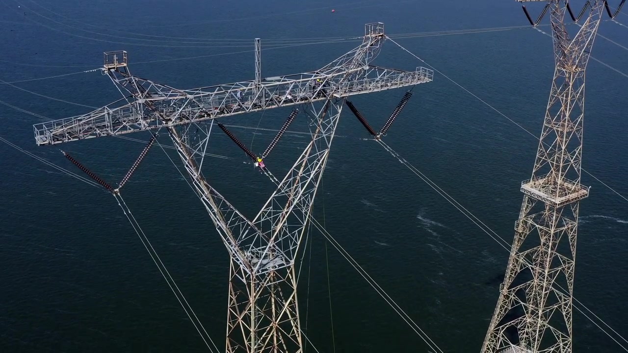 Electricity high-voltage power lines energy sector infrastructure transmission towers over water