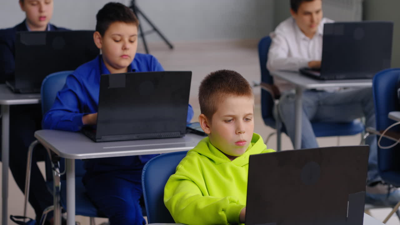 Students working on laptops in a classroom