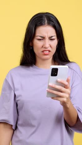 a woman looking disgusted while looking at her phone
