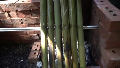 lemang cooking, a type of bamboo rice. lemang is made of glutinous rice that is cooked with coconut milk in hollowed bamboos. it is commonly found in brunei, indonesia, malaysia and singapore.