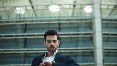 Closeup-businessman-walking-downstairs-outside.-Man-checking-time-on-wristwatch