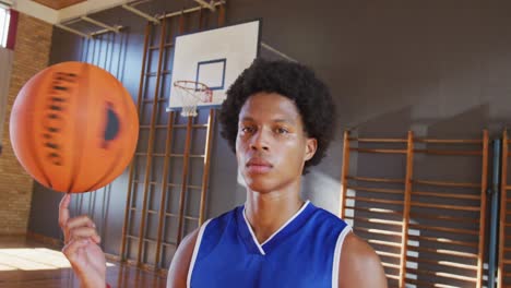 portrait of african american male basketball player holding ball