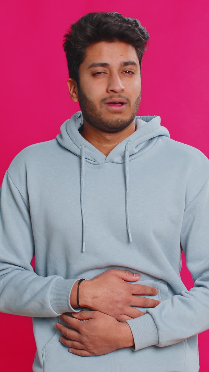 Indian man feeling sudden strong abdominal stomach ache gastritis problem diarrhea poisoning