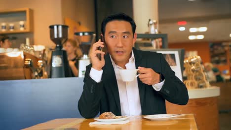 businessman with coffee while talking on mobile phone 4k