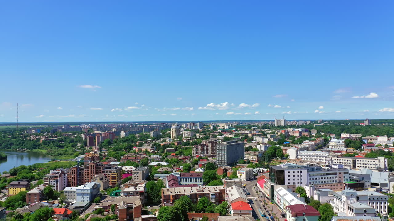 View of the city on wonderful sunny day. Modern block of flats together with green trees. Top view.