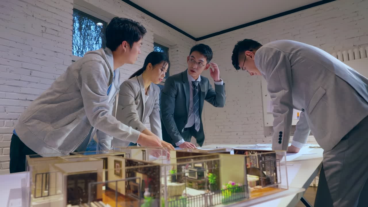 Top view of architects reviewing blueprints and brainstorming idea about house project in modern office