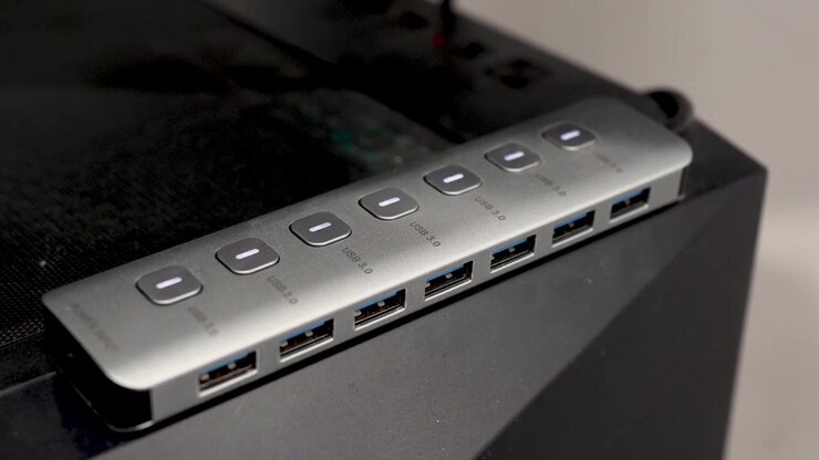 Multiple USB ports. It connects various devices easily with a simple setup. The hub is placed on a computer tower for easy access.